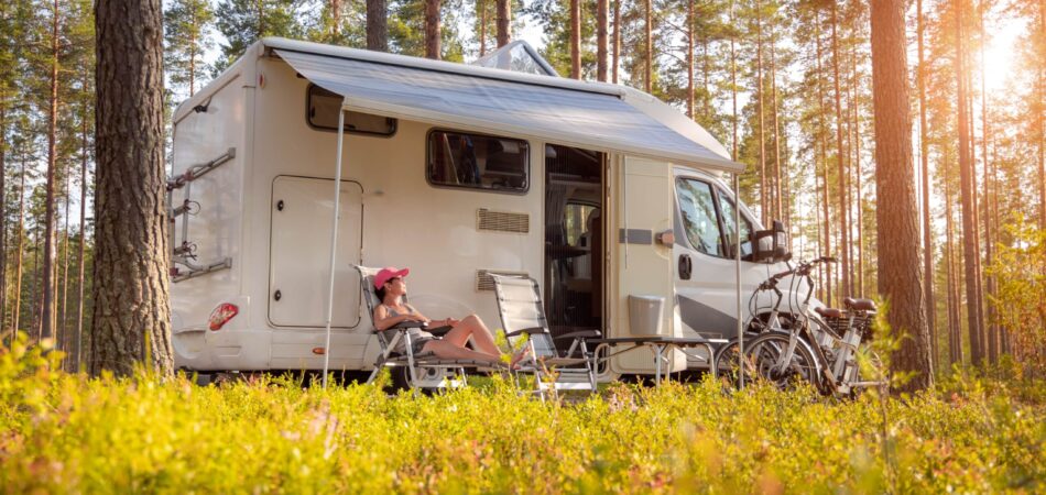 Rv In The Forest With Sun Shinning Down